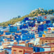 Aerial view of Chefchaouen, Morocco's blue medina with traditional buildings painted in vibrant blue and white, nestled again